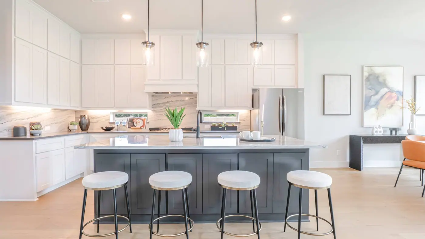 Kitchen with island and seating in the Collinsbrook Farm model-home gallery