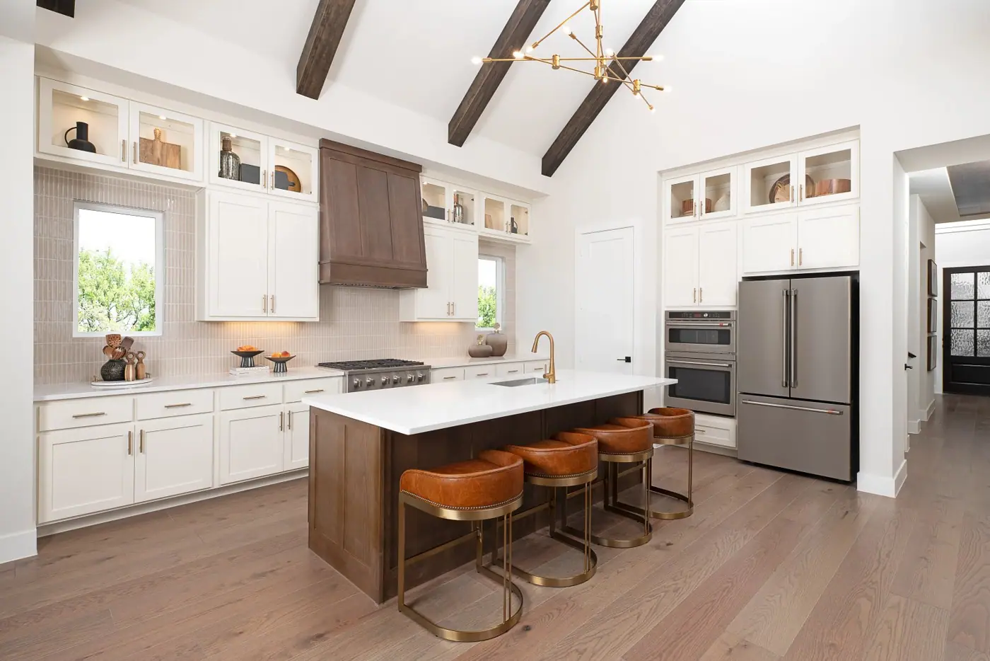 Kitchen with island and exposed ceiling beams in the Ashton Woods Graham model