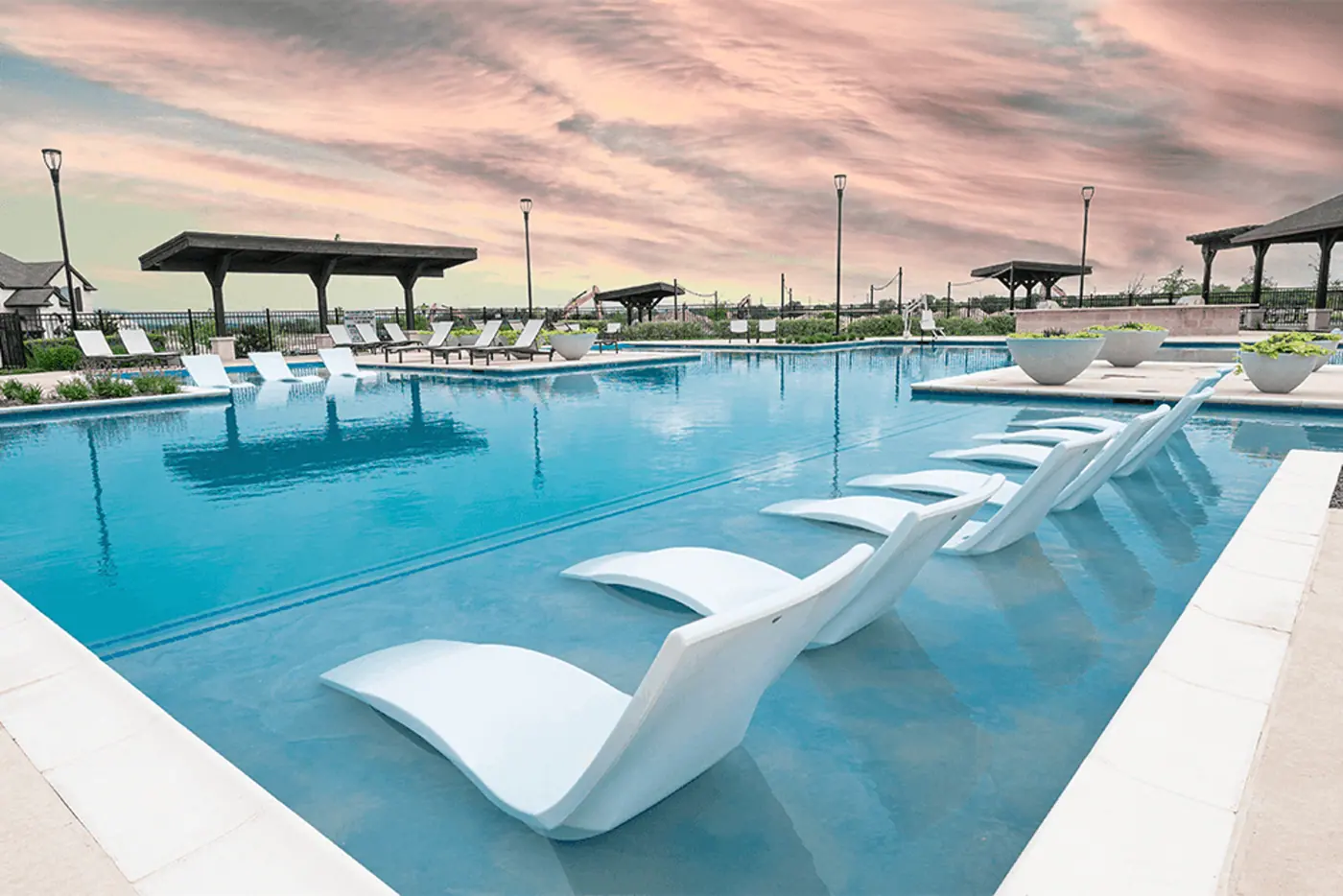 Pool with in-water lounge seating pictured in the Collinsbrook Farm community gallery
