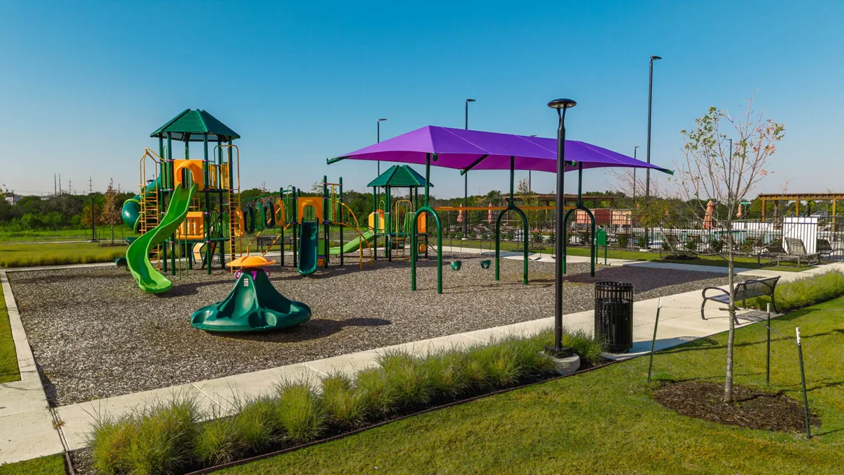 Hazelwood playground with shade structures and surrounding landscaping