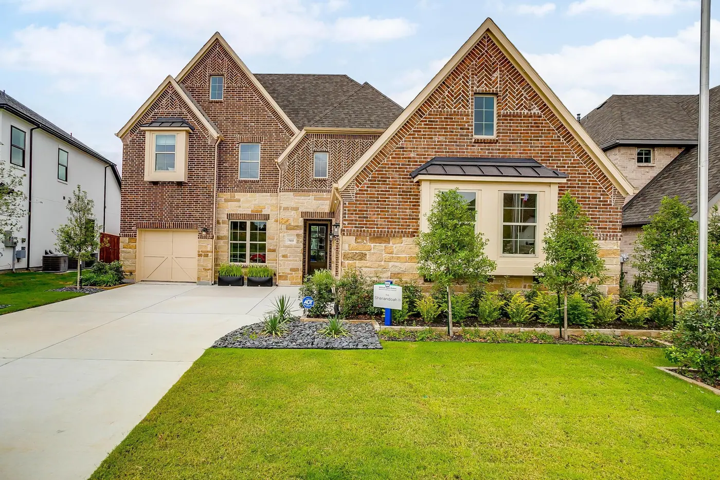 Brick home pictured in William Ryan Homes’ Aster Park community gallery